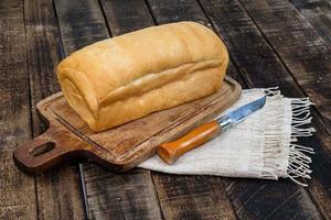 loaf bread isolated on wood background photo