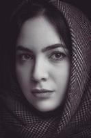 Black and white portrait of a woman wearing a black shawl photo