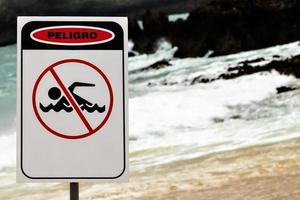 No Swimming sign on a beach in Cantabria, Spain. Horizontal image. photo