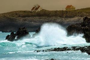 Waves crashing on the rocks of a beach in Cantabria, Spain. Horizontal image. photo