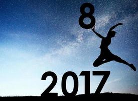 Silhouette young girl. Happy 2018 new year. Background of the Milky Way galaxy on a bright star dark sky tone. Concept change year 2017 to 2018 photo