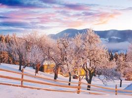 Amazing mountains in the morning sunlight. Small cozy village. Carpathian, Ukraine, Europe. Beauty world. Happy New Year photo