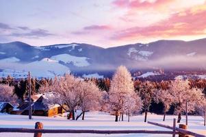 Amazing mountains in the morning sunlight. Small cozy village. Carpathian, Ukraine, Europe. Beauty world. Happy New Year photo