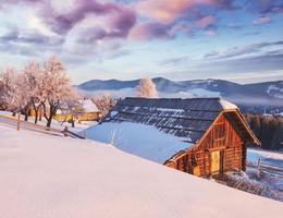 Amazing mountains in the morning sunlight. Small cozy village. Carpathian, Ukraine, Europe. Beauty world. Happy New Year photo