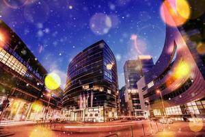 Panorama of the night city of Dusseldorf in winter during a snowstorm. Bokeh light effect, soft filter