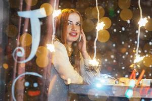 Young beautiful woman sitting in cafe, drinking wine. Christmas, new year, Valentines day, winter holidays concept photo