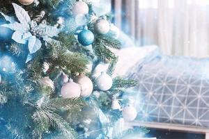 Close up of colorful ornaments on Christmas tree. Happy New Year and Christmas. Bokeh light soft effect photo