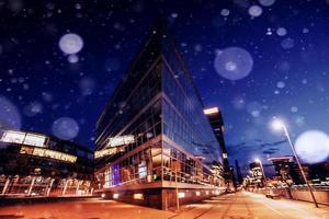 Panorama of the night city of Dusseldorf in winter during a snowstorm. Bokeh light effect, soft filter photo