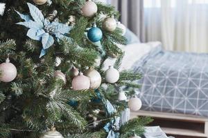 Close up of colorful ornaments on Christmas tree photo