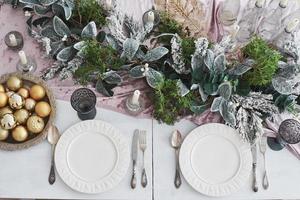 Table served for Christmas dinner in living room, top view photo