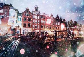 Beautiful calm night view of Amsterdam city during a snowstorm. Bokeh light effect, soft filter photo