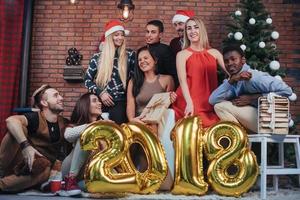 Group of Cheerful old friends communicate with each other. New 2018 Year is coming. Celebrate the new year in a cozy home atmosphere photo