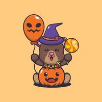 Cute bear wearing witch hat holding halloween balloon and candy vector