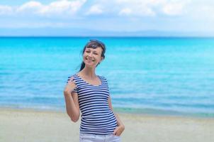 Young beautiful girl with striped t-shirt and sunglasses looking at camera and smile photo