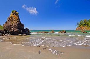 Surf and foam on an ocean shore photo