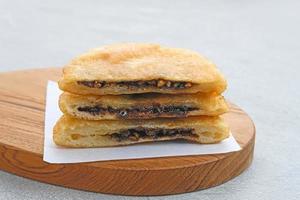 Hotteok, South Korean pancakes or fried dough with nuts and sugar filling, traditional street food. Selected focus.