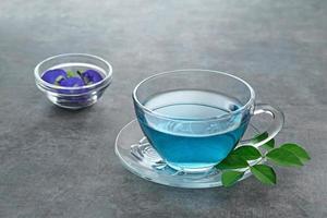 Teh Telang, Butterfly flower tea or Blue Tea is herbal tea made from the herb or infusion of the Clitoria ternatea plant flower. photo