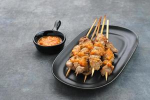 Sate Taichan, Grilled Chicken Satay without peanut sauce or soy sauce. Served on plate with chilli sauce. photo