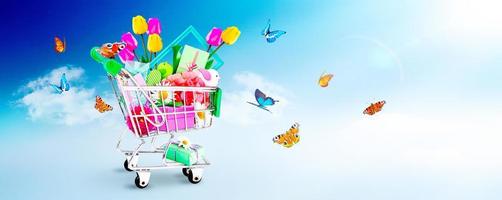 Mini shopping cart with colorful flowers and butterflies. photo