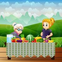 anciana y una mujer embarazada con diferentes frutas en la mesa vector