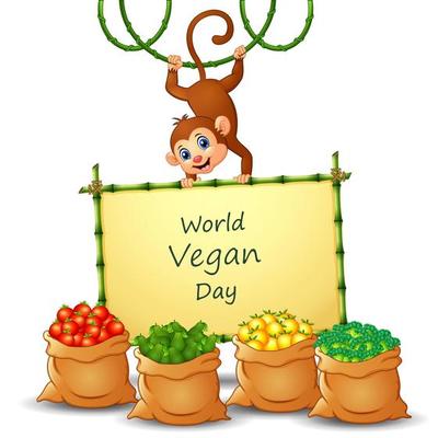 World Vegan Day text design on sign with vegetables and monkey