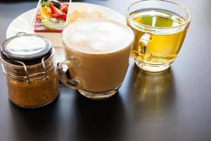 strawberry cream and a cup of tea and coffee on a wooden background, selective focus photo