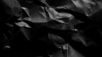 black crumpled paper texture background with copy space for text or image photo