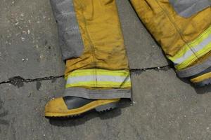 Firemen in firefighter uniform after use photo