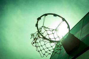 Wooden basketball hoop during sunset. photo