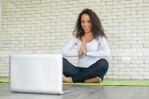 Latin woman teaching yoga online photo