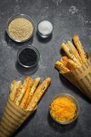 Cheese Straws and Sesame Seeds In A Paper Cone photo