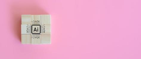 Wooden block with artificial intelligence or ai on pink background. Connection of technology and innovation, machine learning. Technology and science concept. photo