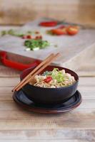instant noodles with shiitake pepper and chilli n a bowl, Asian meal on a table photo