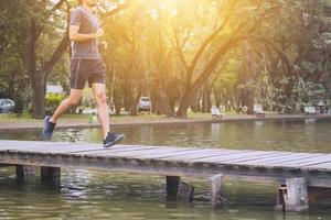 runner man running on wood bridge over canal