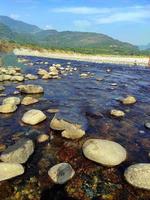 Stone in river water. nature scene photo