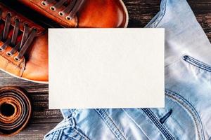 Mock up of male brown leather shoes, blue jeans and belt with white blank sheet photo