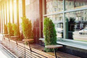 Street view on empty chairs of coffee terrace photo