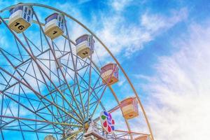 Ferris wheel on cloudy blue sky photo