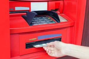 Woman's hand takes cash USD from ATM photo