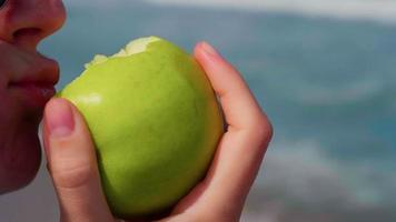 Woman eating apple, healthy snack video