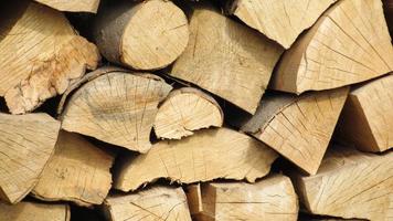stack of firewood. Chopped wooden logs stacked in the woodpile photo