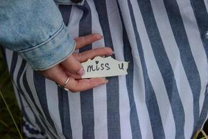 Hand of a girl with the words miss you photo