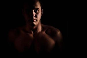 Close-up portrait of young muscular shirtless nake male bodybuilder man with athletic body photo