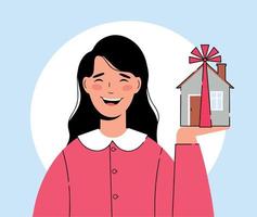 Happy woman holds a new house in her hand. Purchase or donation of housing vector