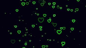 Green heart particle motion background. Faded wallpaper animation with black color. Flying bubble. video