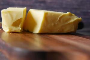 slice of a butter on a paper on table photo