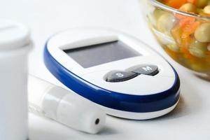 Close up of diabetic measurement tools and pills on color background photo
