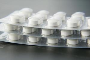 Close up of pills of blister pack on table photo