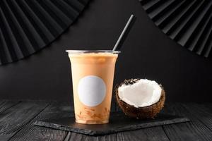 Taiwan milk tea with coconut and mango on wooden background photo
