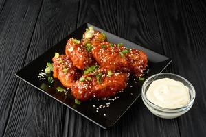 Chicken wings. Traditional asian recipe. Dark background. Copy space. Top view. photo